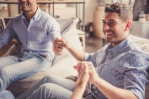 people holding hands in group therapy