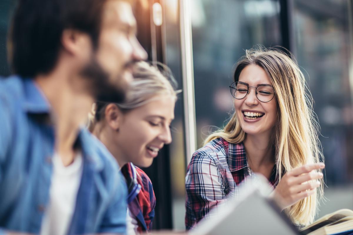 a group of people laughs together as they participate in support groups