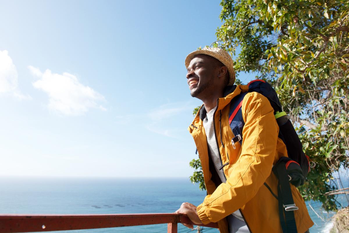 3 Reasons to Start the New Year Sober man looking towards the ocean in a yellow jacket