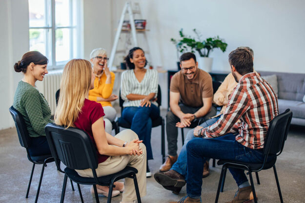 Qualities of a Top Drug Rehab Center in Pennsylvania a group of people sit in a circle in chairs during a Pennsylvania drug rehab