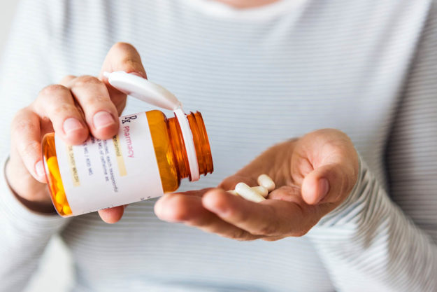 What is Pharmacotherapy and How Does it Work a person holds pills as part of their Pharmacotherapy regimen
