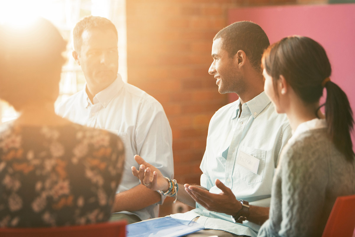 How Intensive Outpatient Programs are Used to Treat Mental Health a group of people sit in a circle and talk about outpatient mental health programs