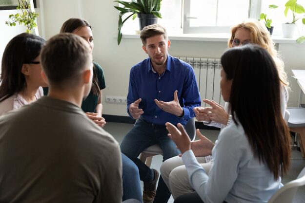 a group of people sit in a circle and participate in residential treatment near reading pa