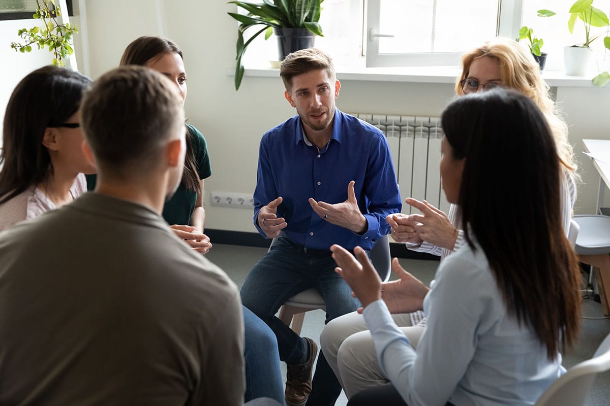 a group of people sit in a circle and participate in residential treatment near reading pa