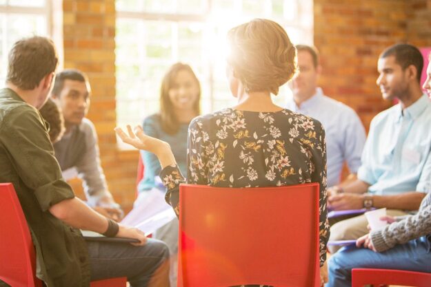 a group of people sit in a circle and talk in a Residential Treatment Near Pottsville, PA