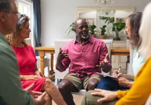 a group of people sit in a circle and discuss Polysubstance Abuse treatment