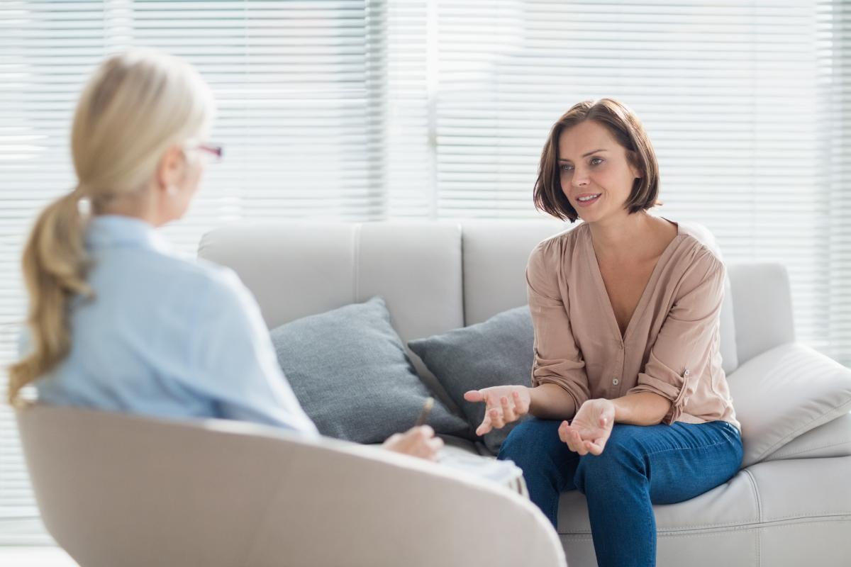a patient sitting on a couch asks a therapist how do you treat painkiller addiction
