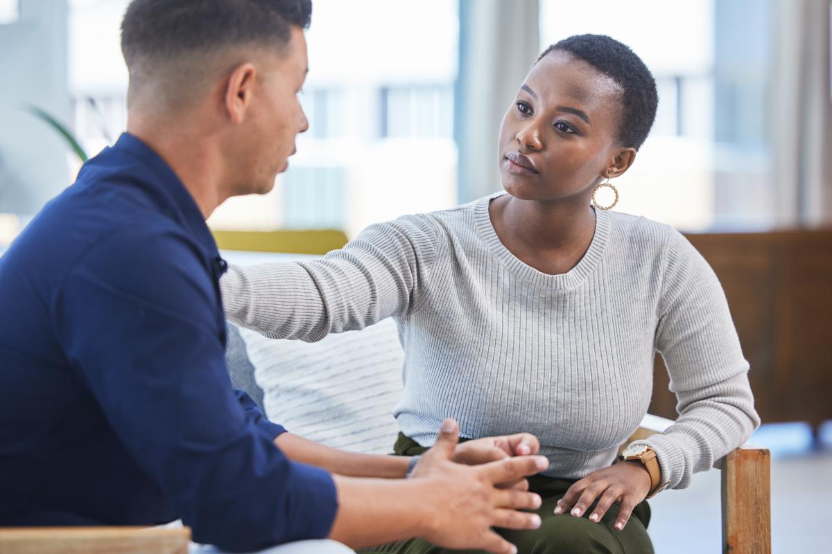 The Role of MAT in Overcoming Addiction A therapist speaks with a client about the MAT recovery program.