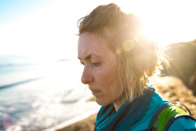 What Does Meth Withdrawal Look Like_ A woman on the beach is experiencing meth withdrawal symptoms.