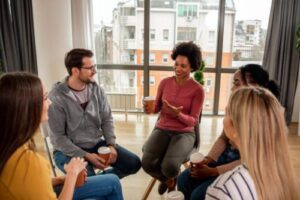 A woman is sharing while in a small group for acceptance and commitment therapy in Mechanicsburg, PA.