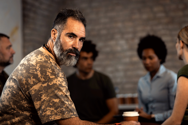 How-Does-PTSD-Impact-Addiction-Recovery-in-Veterans A man struggling with PTSD and addiction is in recovery.