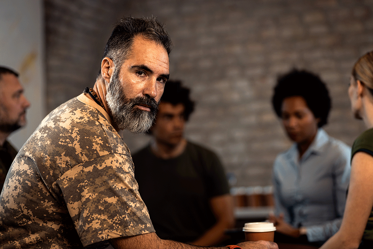 How-Does-PTSD-Impact-Addiction-Recovery-in-Veterans A man struggling with PTSD and addiction is in recovery.