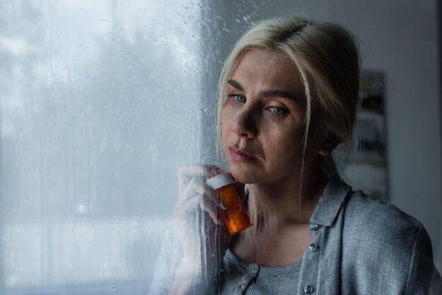 benzos-and-alcohol-risks a woman holding a bottle of benzos