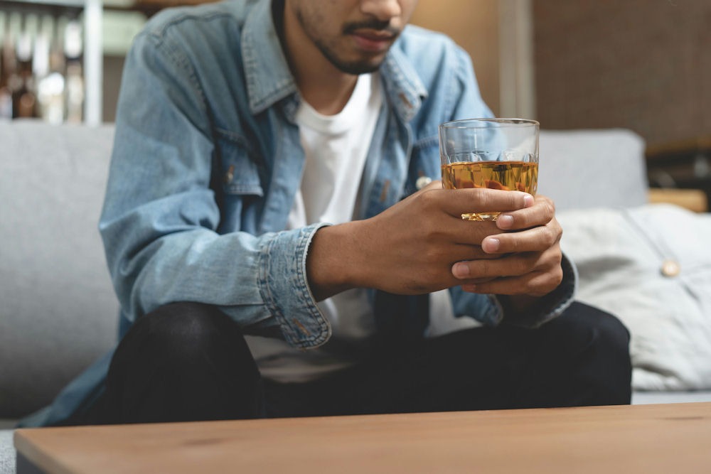 a man holding a glass of beer