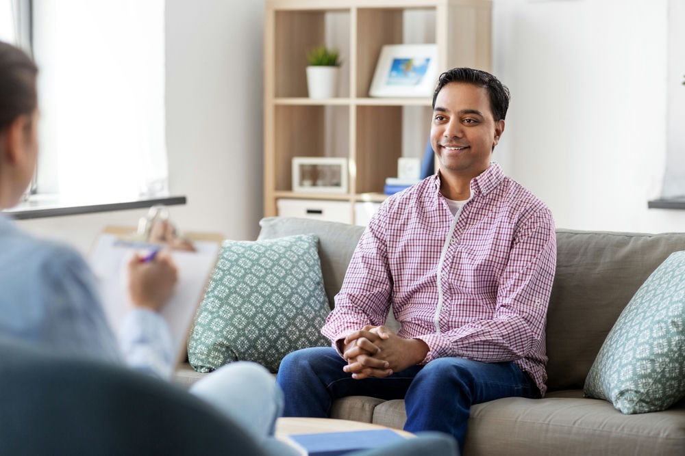 a man smiling in therapy